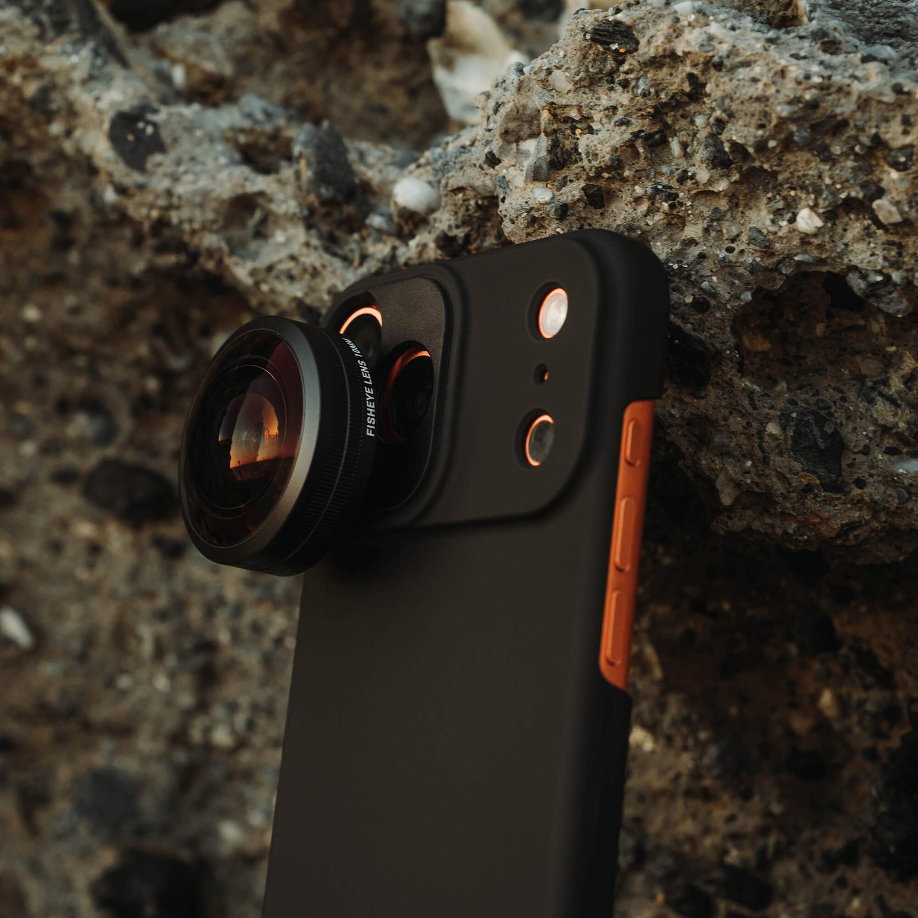 Side angle of iPhone 18 Pro Max Fisheye Lens with beach rock background