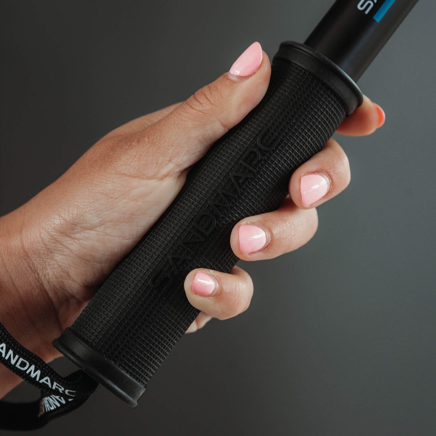 Close up of photographer holding SANDMARC Pole grip