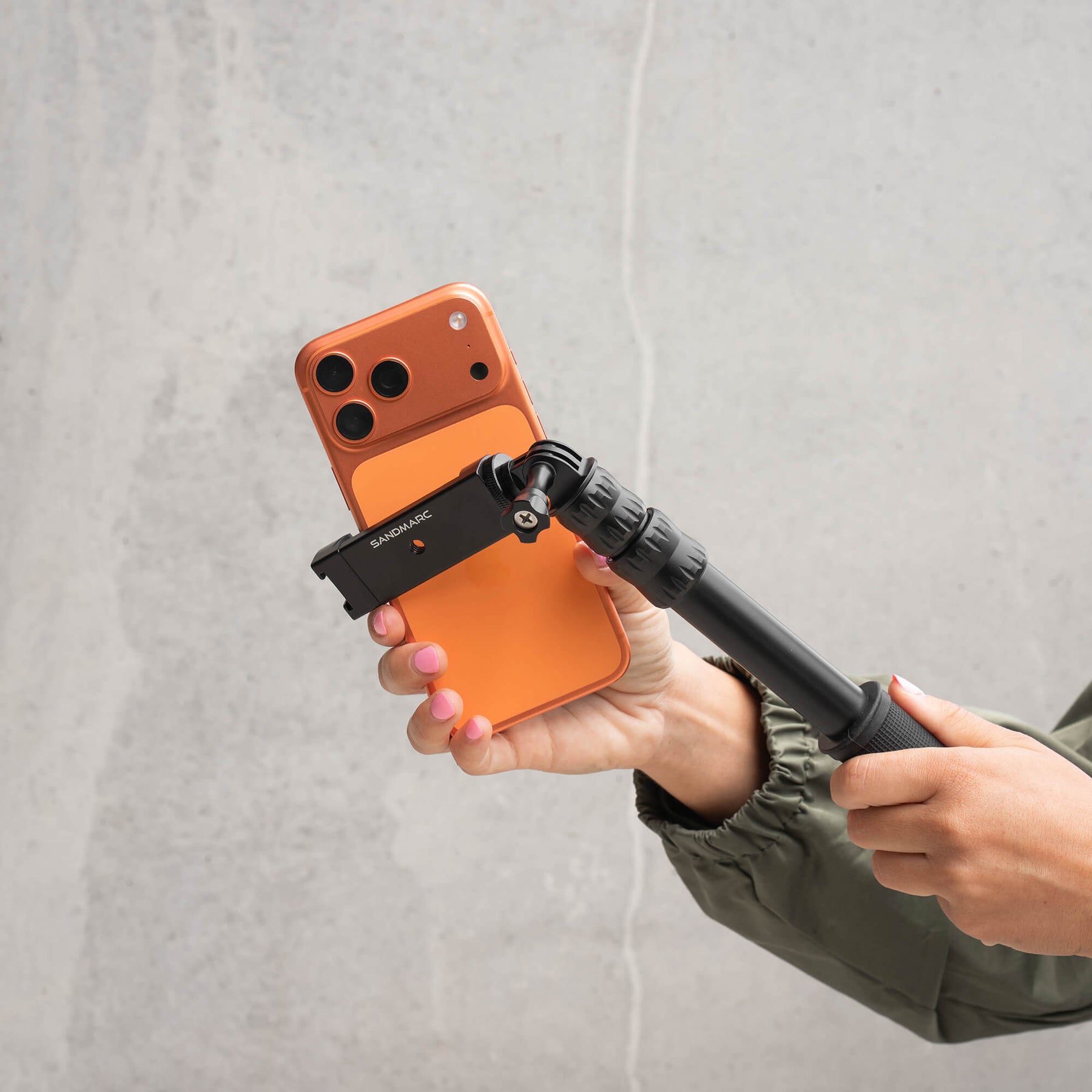 Photographer attaching iPhone 17 Pro Max to SANDMARC Pole