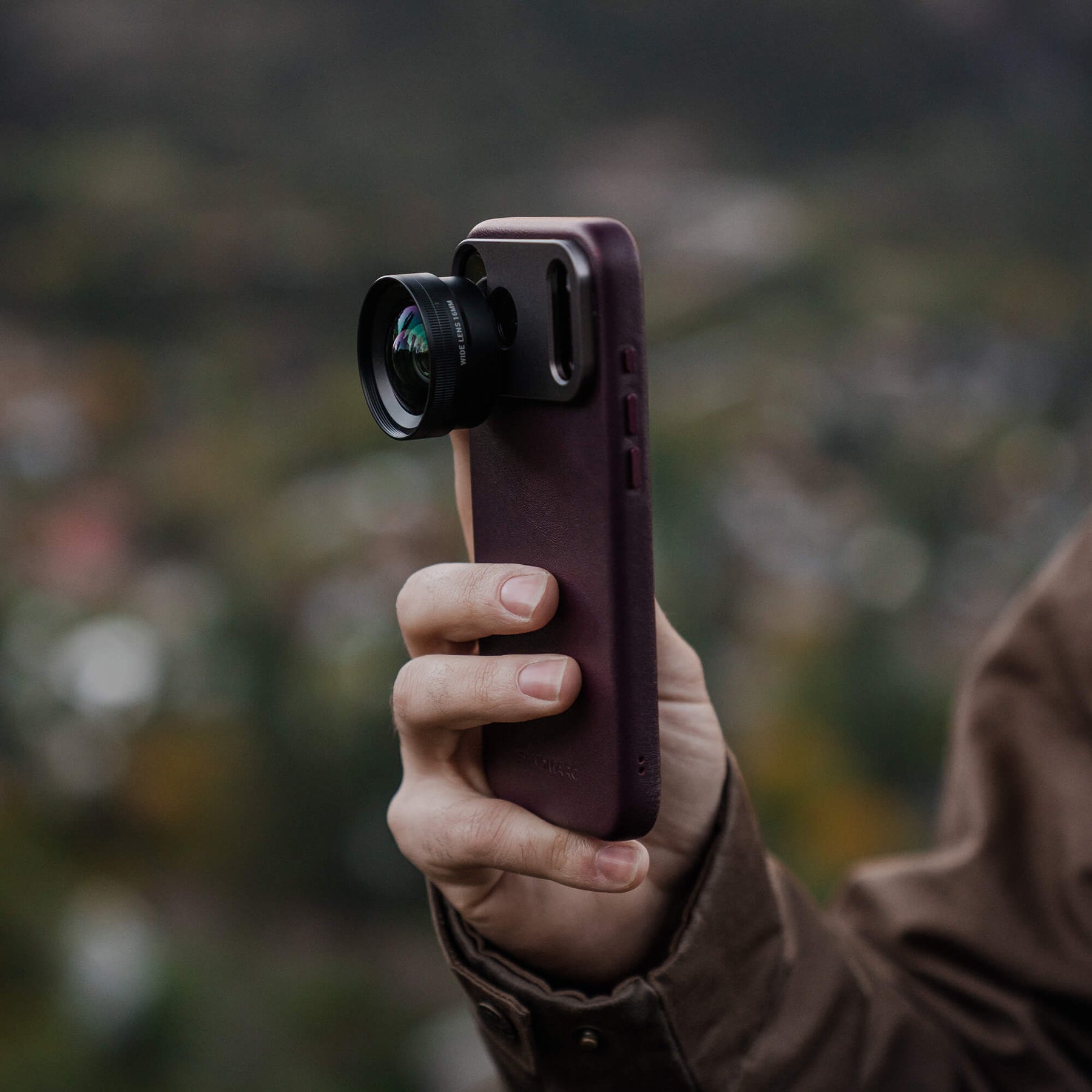 SANDMARC Wide Lens attached to the Pro Leather Burgundy case on the iPhone 18 Pro 