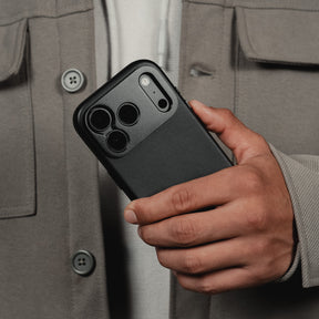 SANDMARC Pro Leather Case for iPhone 18 Pro in Black, shown next to a burgundy iPhone, on an orange background.